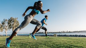 Man and young woman training, sprinting on coast, downtown San Diego, California, USA.Photo: Getty Images