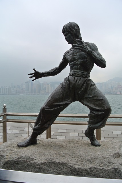 A captivating image of Bruce Lee, the iconic martial artist, showcasing his raw power and intensity as he embraces his legendary status.