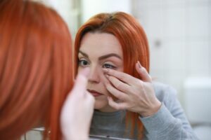 girl wearing contact lenses beyond their recommended replacement schedule.