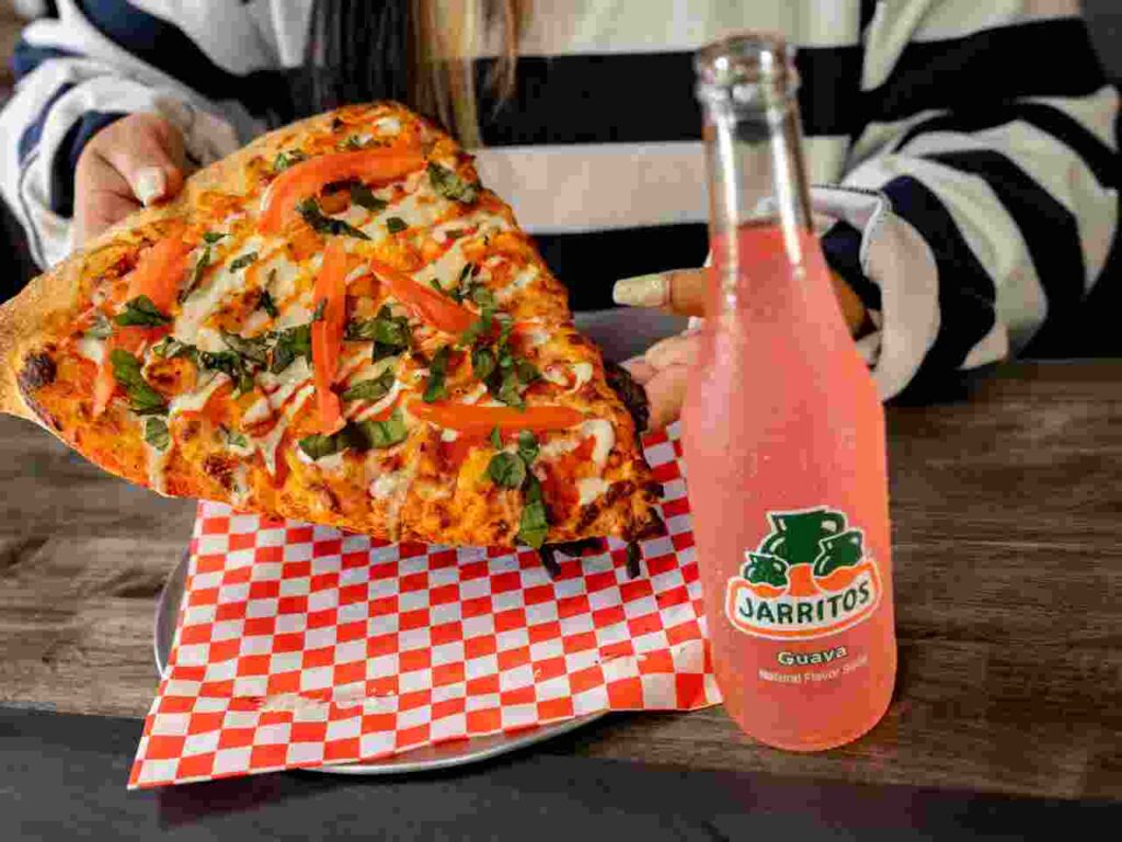 Slice of delicious pizza with melted cheese and toppings.