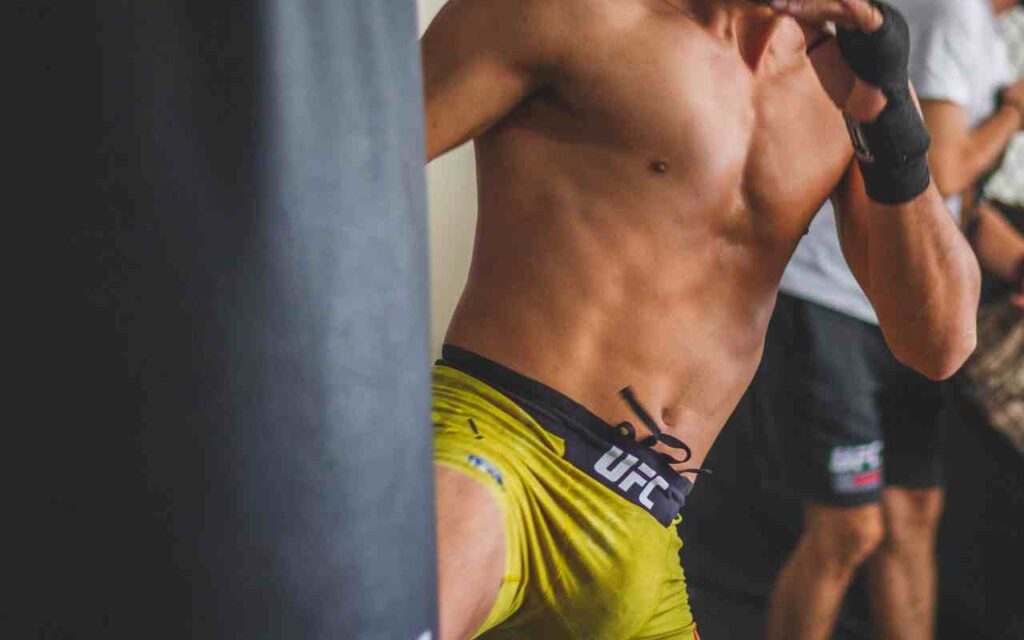 Two UFC fighters in intense battle inside the Octagon.