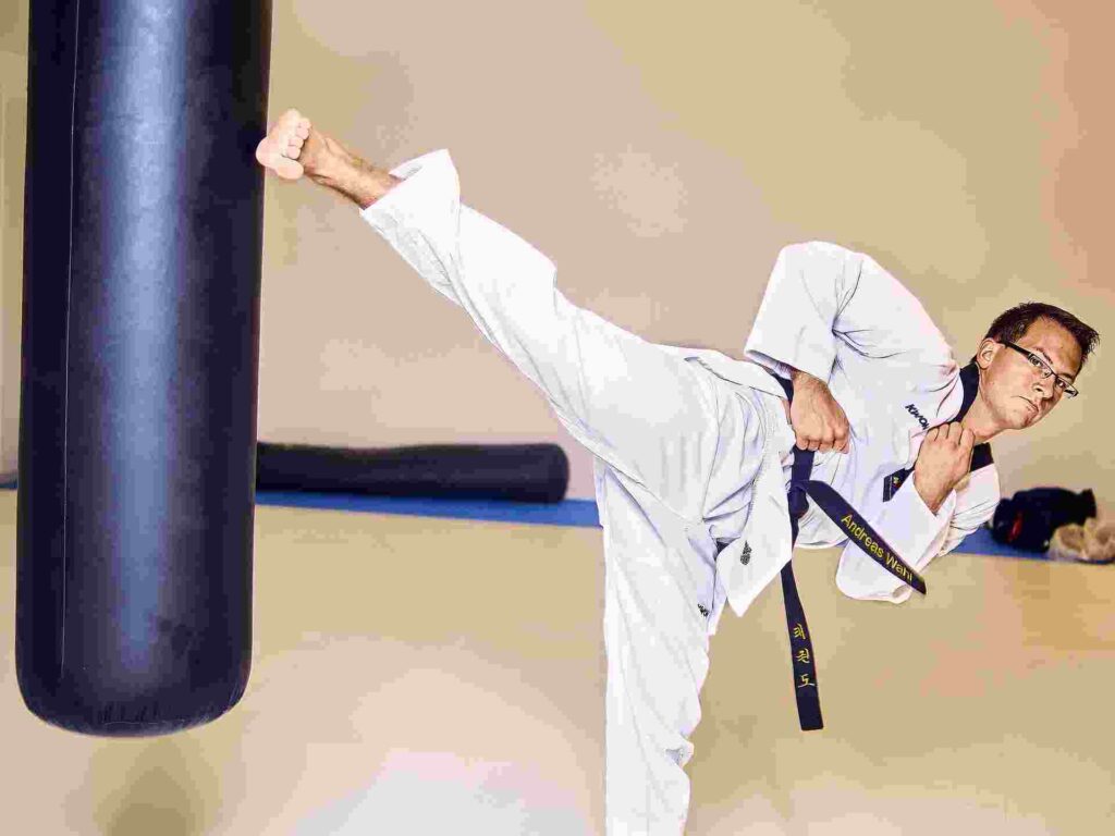 practicing Taekwondo kicks at home.