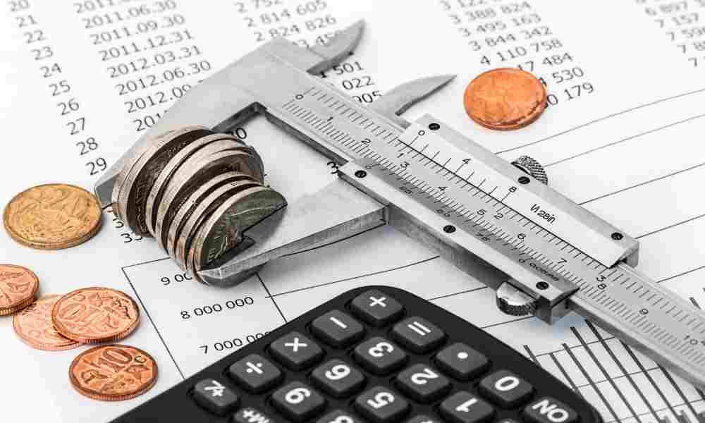 Coins stacked beside a piggy bank, symbolizing money-saving strategies.