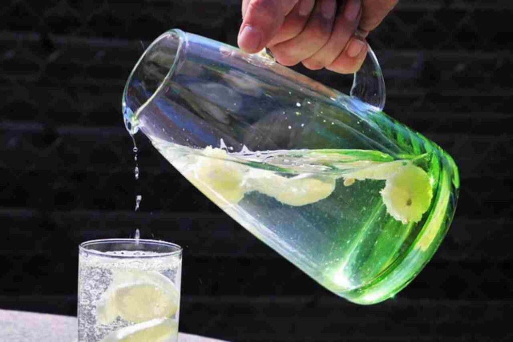 "Refreshing glass of lemon water with lemon slices."