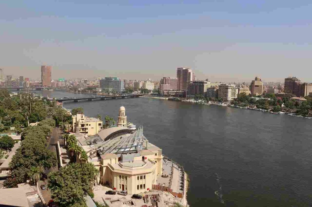 Aerial view of the majestic River Nile winding through lush landscapes, connecting ancient history and vibrant cultures.