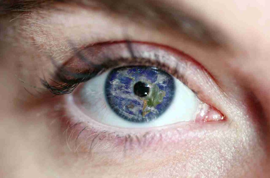 Illustration of a pair of vibrant, healthy eyes surrounded by colorful fruits and vegetables.