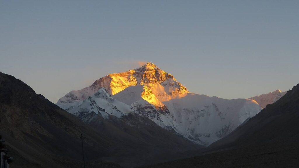 A breathtaking image of Mount Everest, the world's tallest mountain, shrouded in snow and clouds.