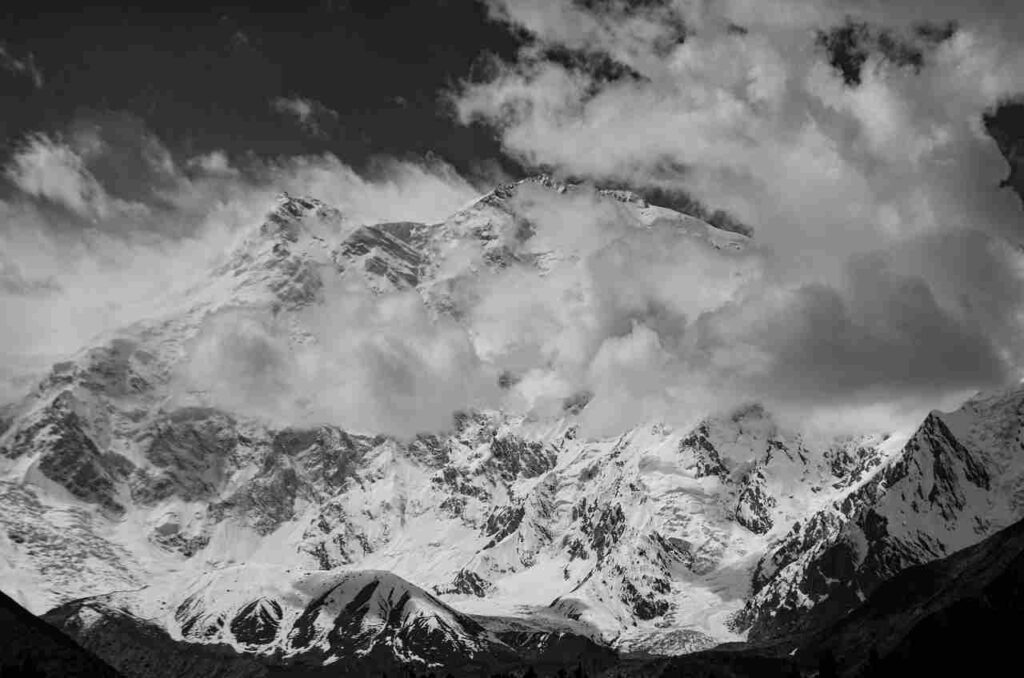 A breathtaking image of Mount Everest, the world's tallest mountain, shrouded in snow and clouds.