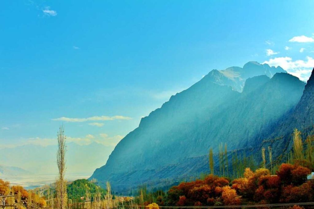 A stunning photograph showcasing the breathtaking beauty of Pakistan, featuring lush green landscapes, majestic mountains, and vibrant cultural elements.