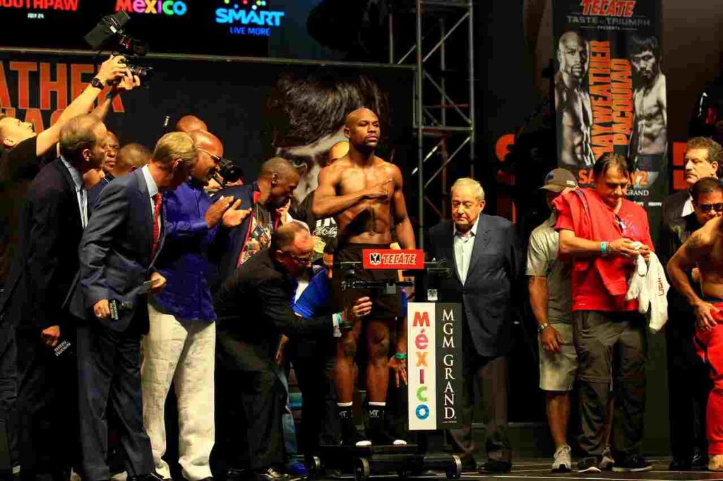 "Floyd Mayweather Jr., the undefeated boxing legend, wearing boxing gloves."