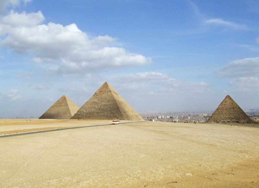 Awe-inspiring Egyptian Pyramids standing tall against a clear blue sky, showcasing the ancient architectural wonders of Egypt