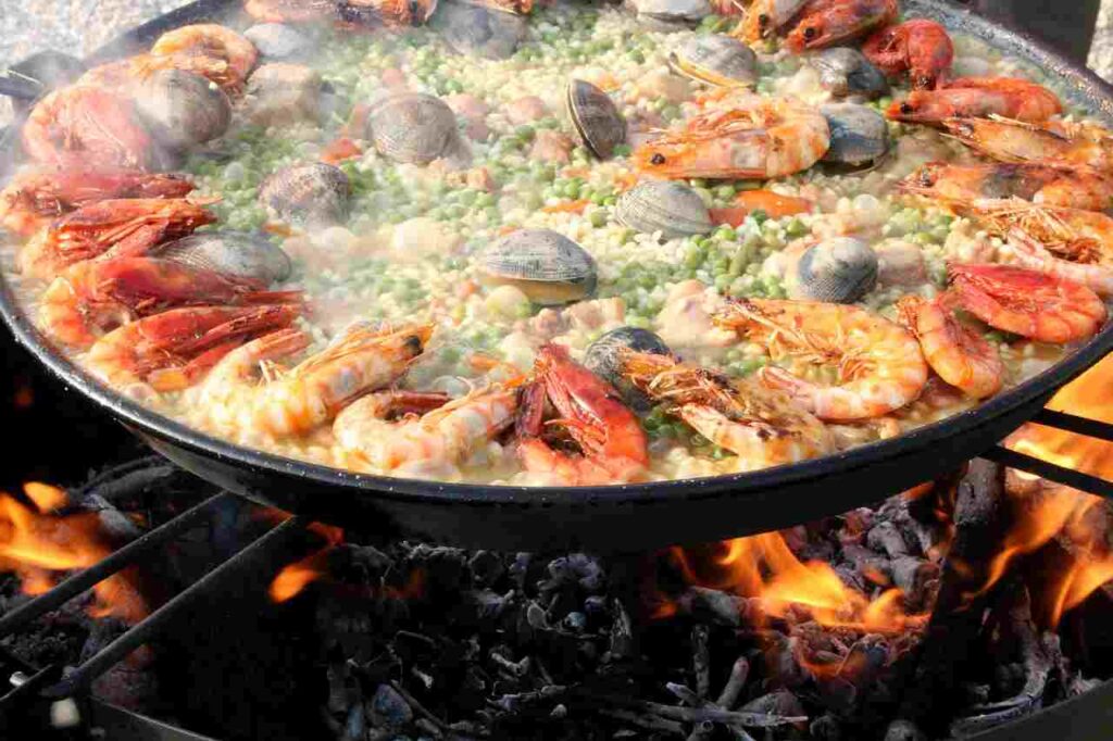 Delicious paella in a traditional pan.