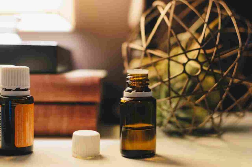 Image of peppermint leaves and essential oil bottle representing peppermint oil's health benefits.
