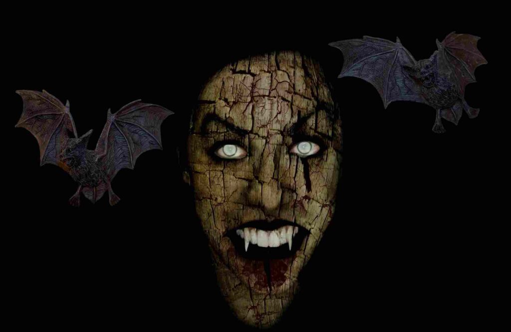 "Image of vampires fangs and blood against a dark background."