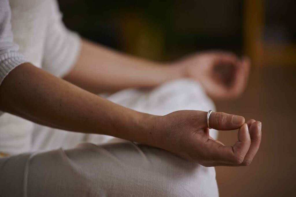 Person meditating in a peaceful yoga pose.