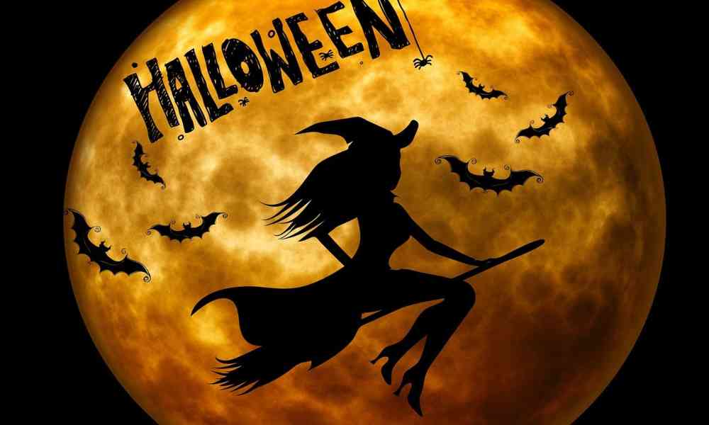 Moonlit Halloween night with jack-o'-lanterns and spooky decorations