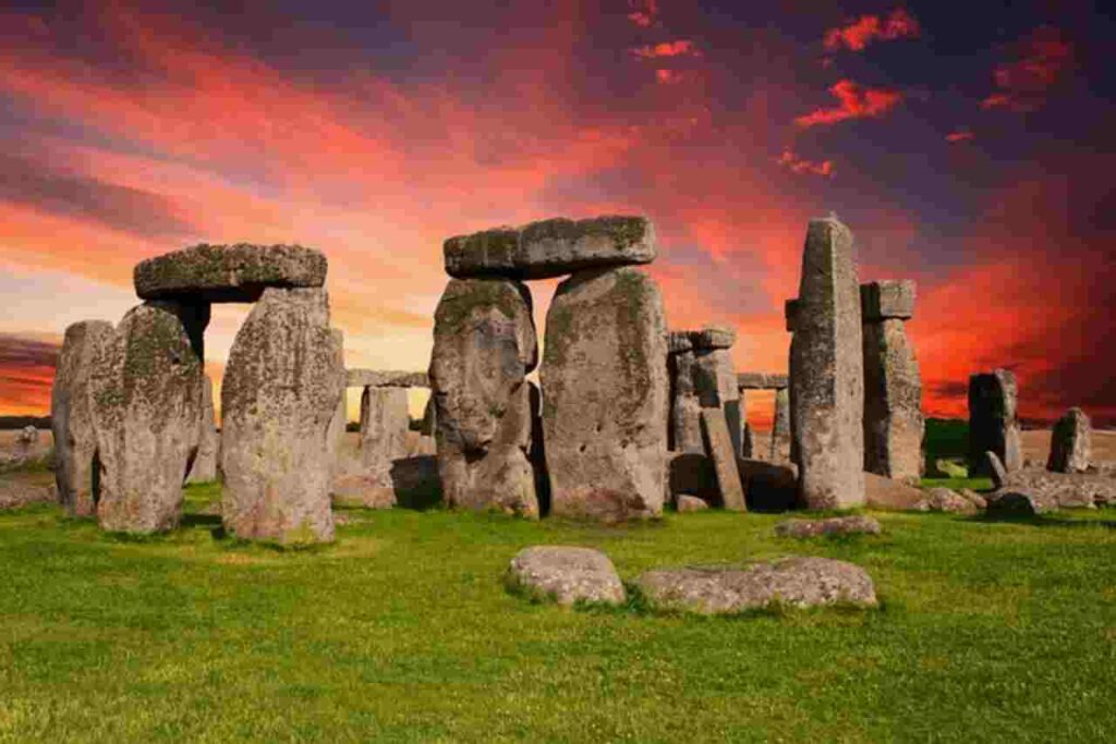 "Image: Stonehenge against the backdrop of the sunrise."