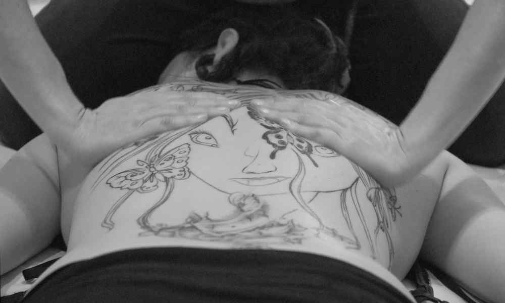 Image of a person giving a relaxing back massage.