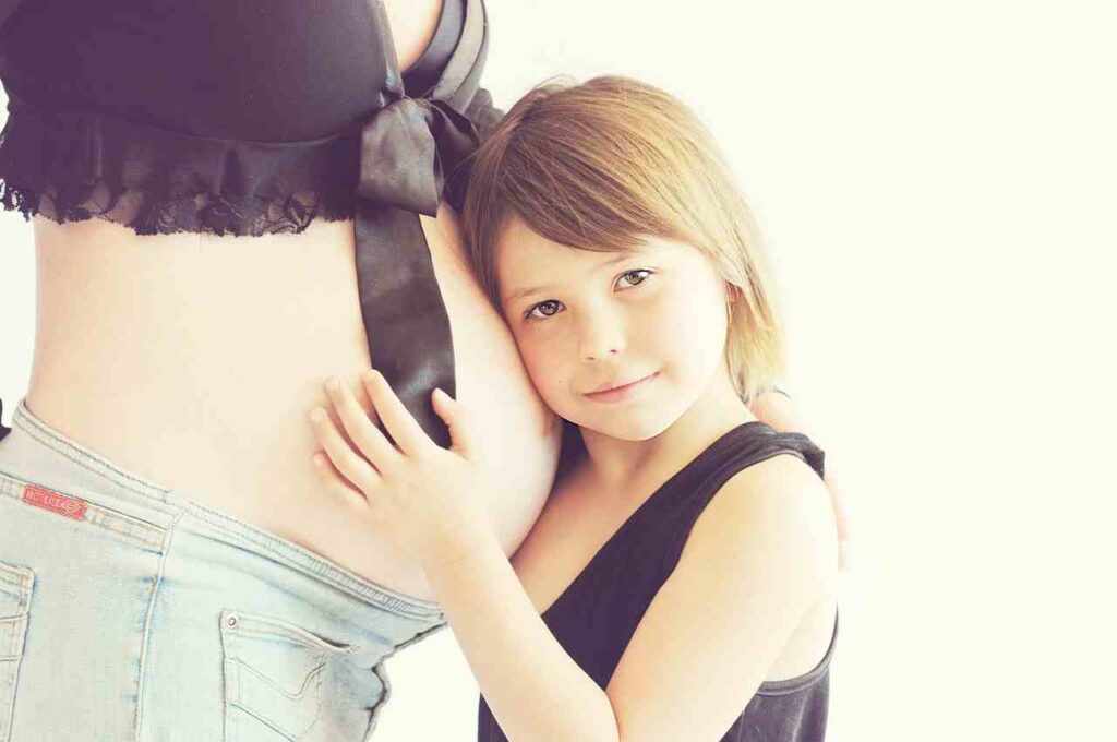 Pregnant woman holding her belly, symbolizing health and wellness during pregnancy