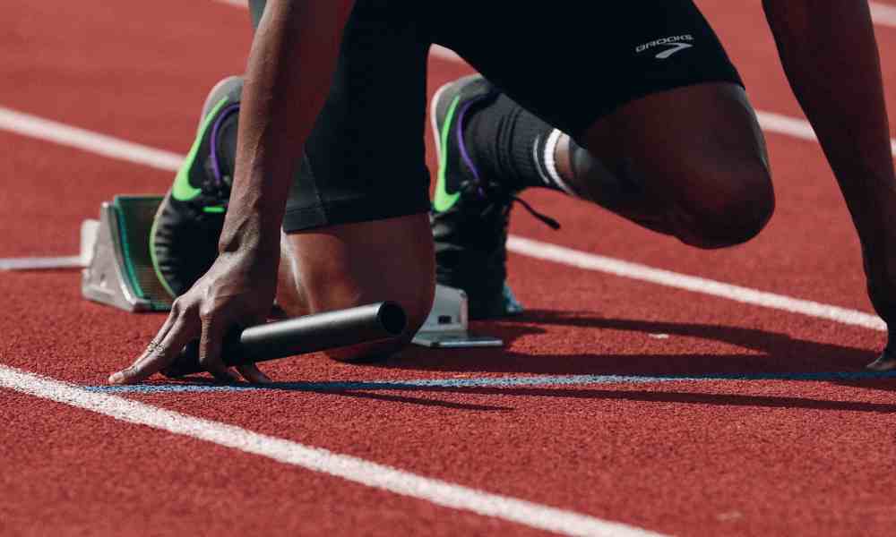 Become an athlete - a person jogging on a track, symbolizing the journey to athletic success.