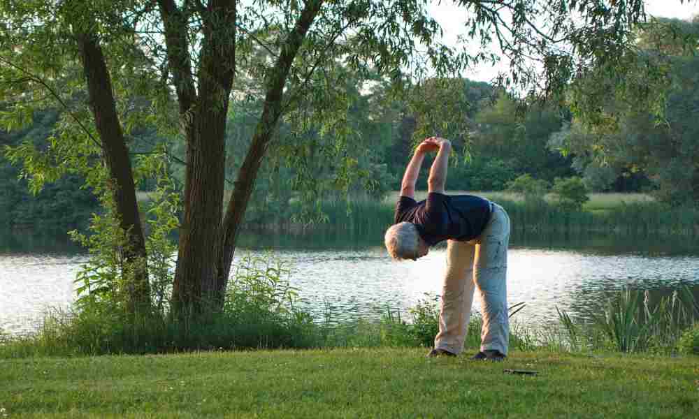 A woman gracefully stretching during a yoga session, showcasing flexibility as a key element of well-being.